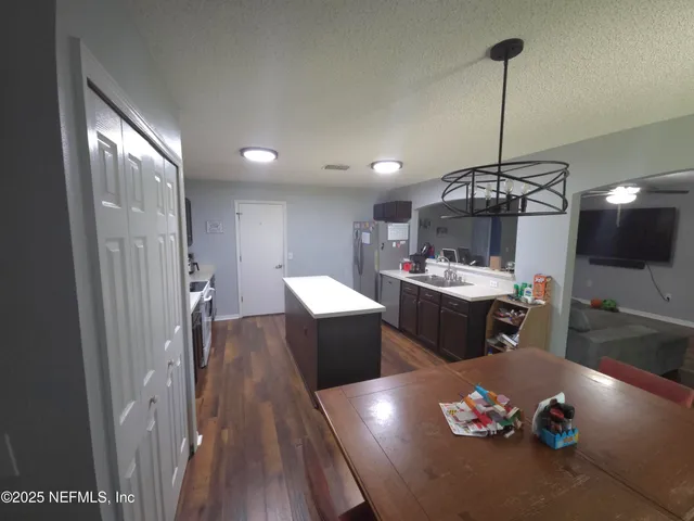 a kitchen with a table and chairs in it