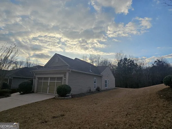 a view of house with backyard and garden