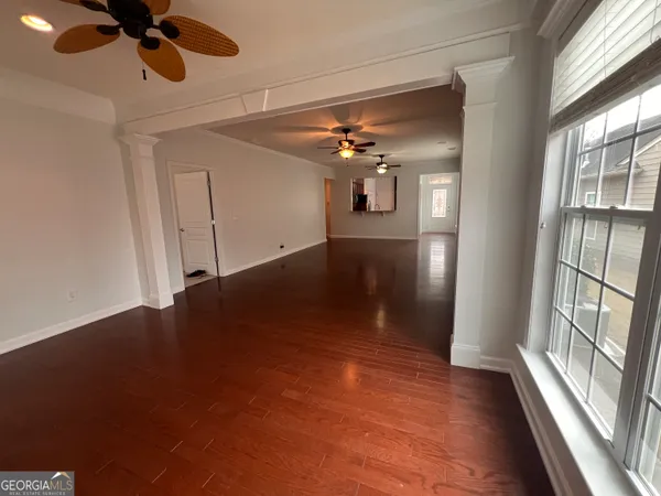 wooden floor in an empty room with a window