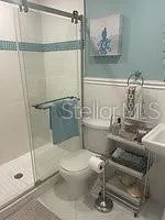 a bathroom with a toilet and a shower