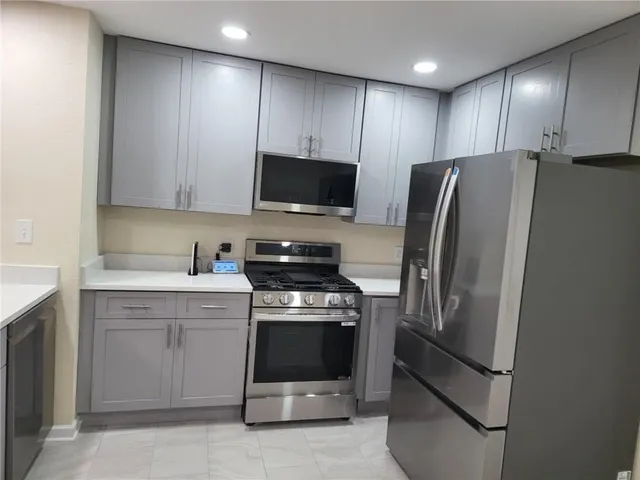 a kitchen with a refrigerator stove and microwave