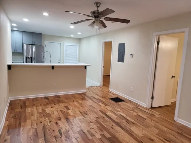 a view of room with wooden floor and ceiling fan