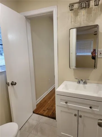 a bathroom with a sink toilet and mirror