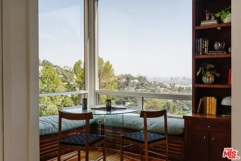 a view of a chairs and table on the balcony