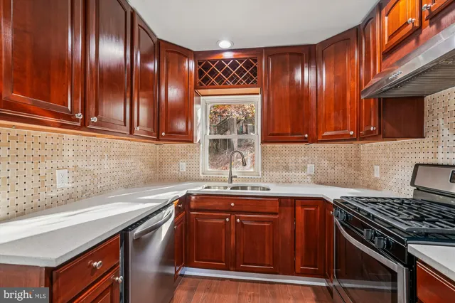 a kitchen with granite countertop stainless steel appliances and sink