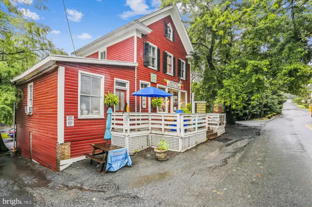 a view of a house with a yard and sitting area