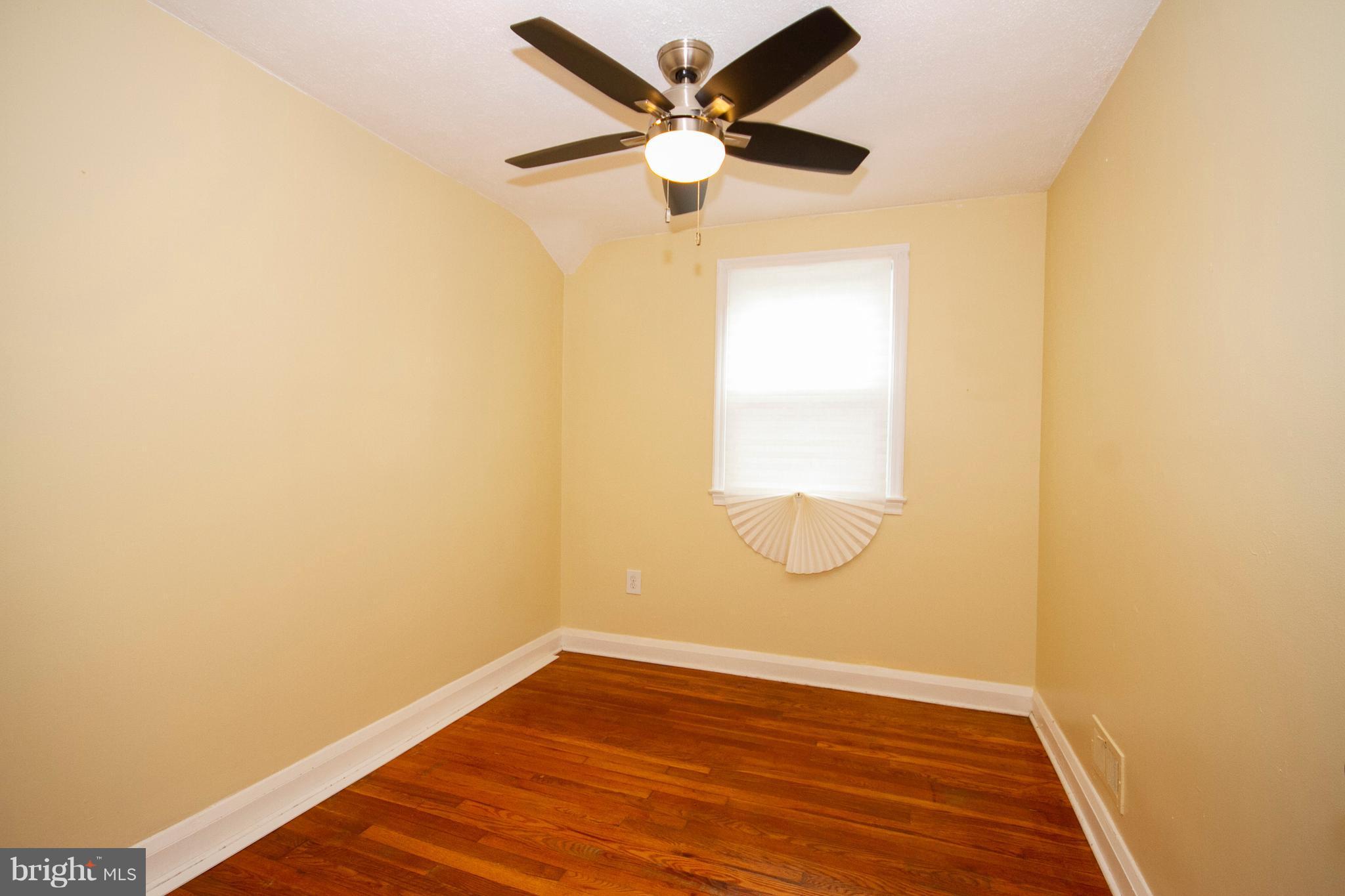 2022 Crestview Road Baltimore, MD 21239 - Photo 11 of 14 an empty room with wooden floor and windows