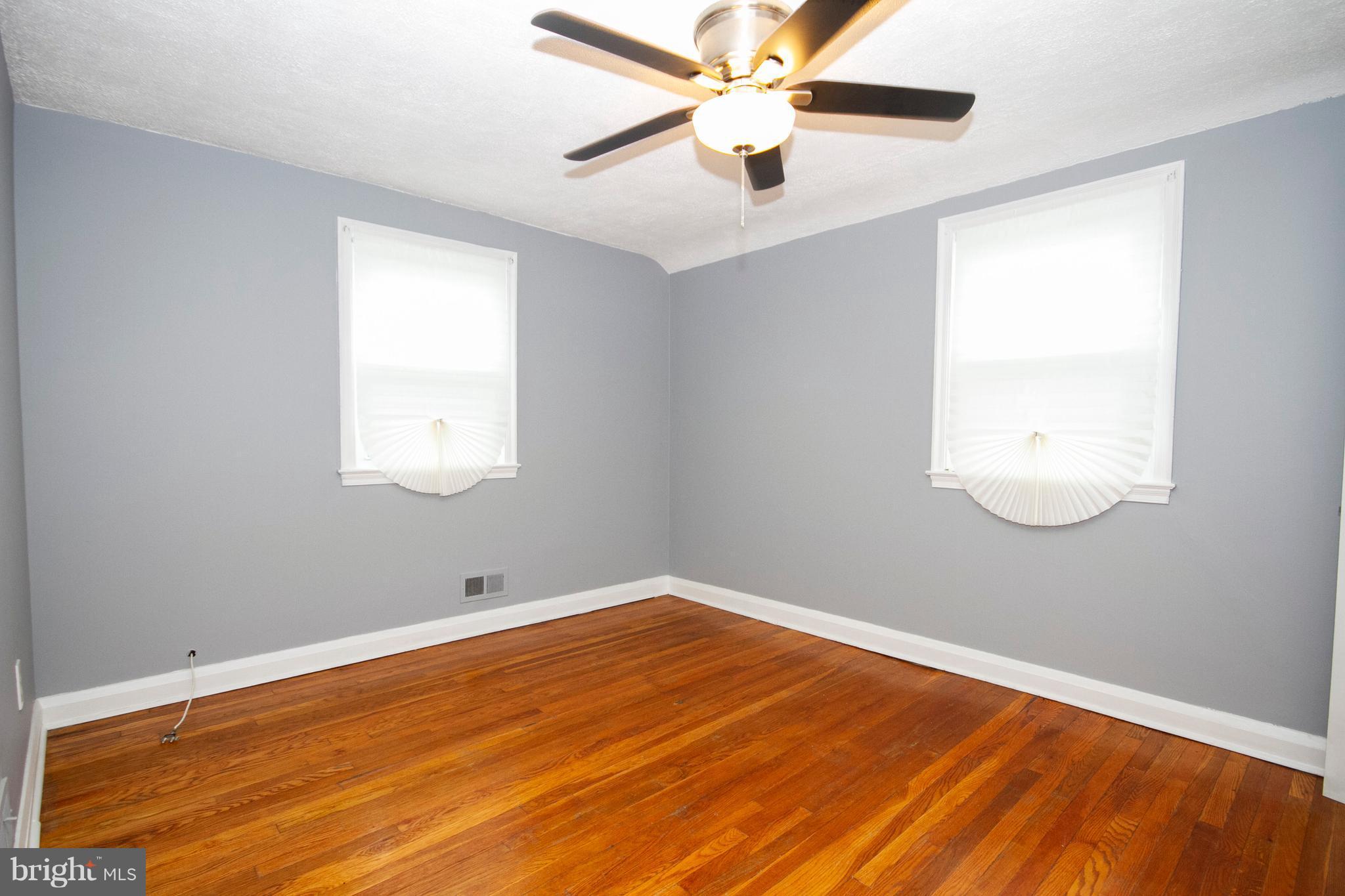 2022 Crestview Road Baltimore, MD 21239 - Photo 12 of 14 an empty room with a window and a fan