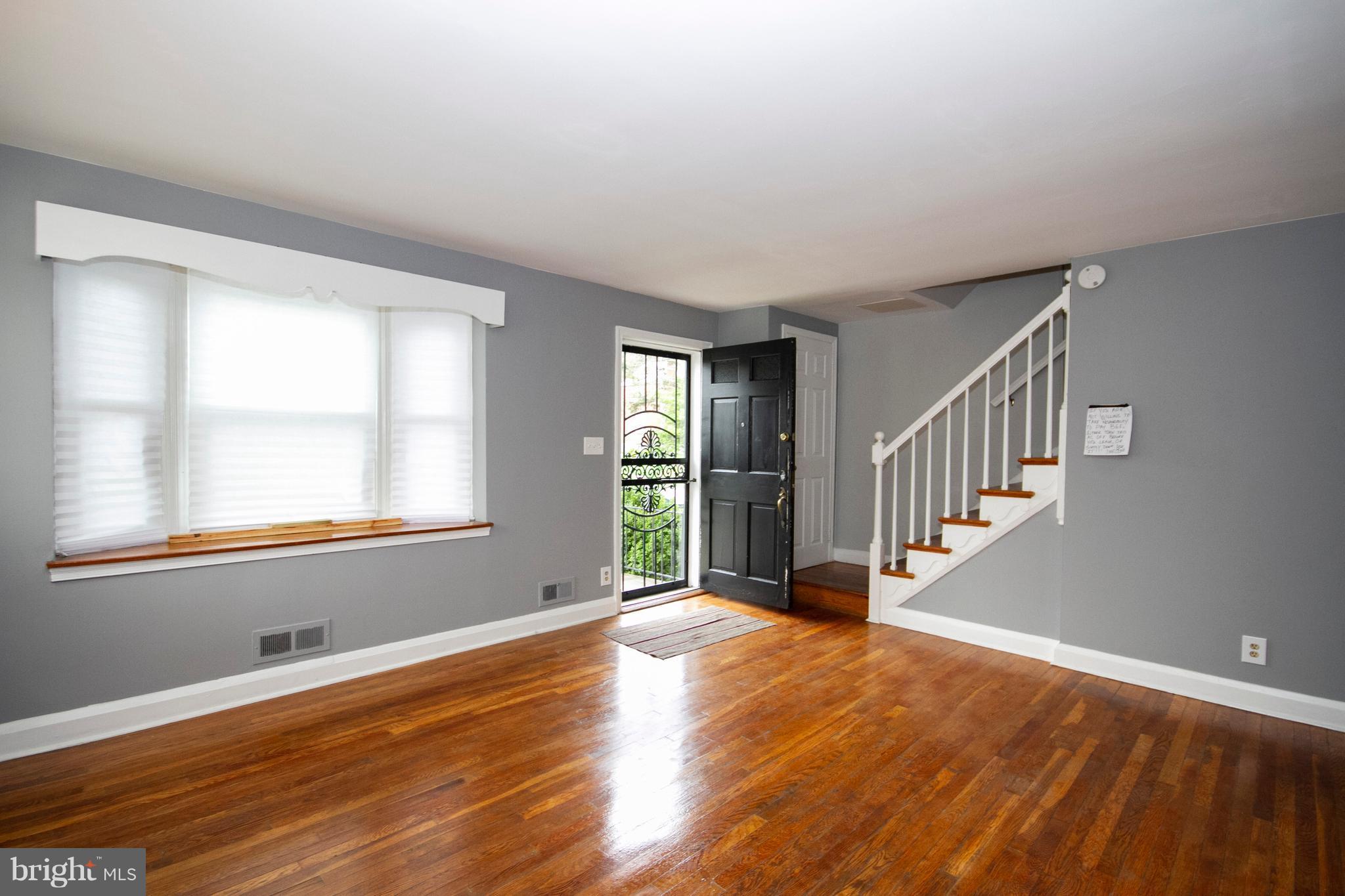 2022 Crestview Road Baltimore, MD 21239 - Photo 4 of 14 a view of an empty room with wooden floor and a window
