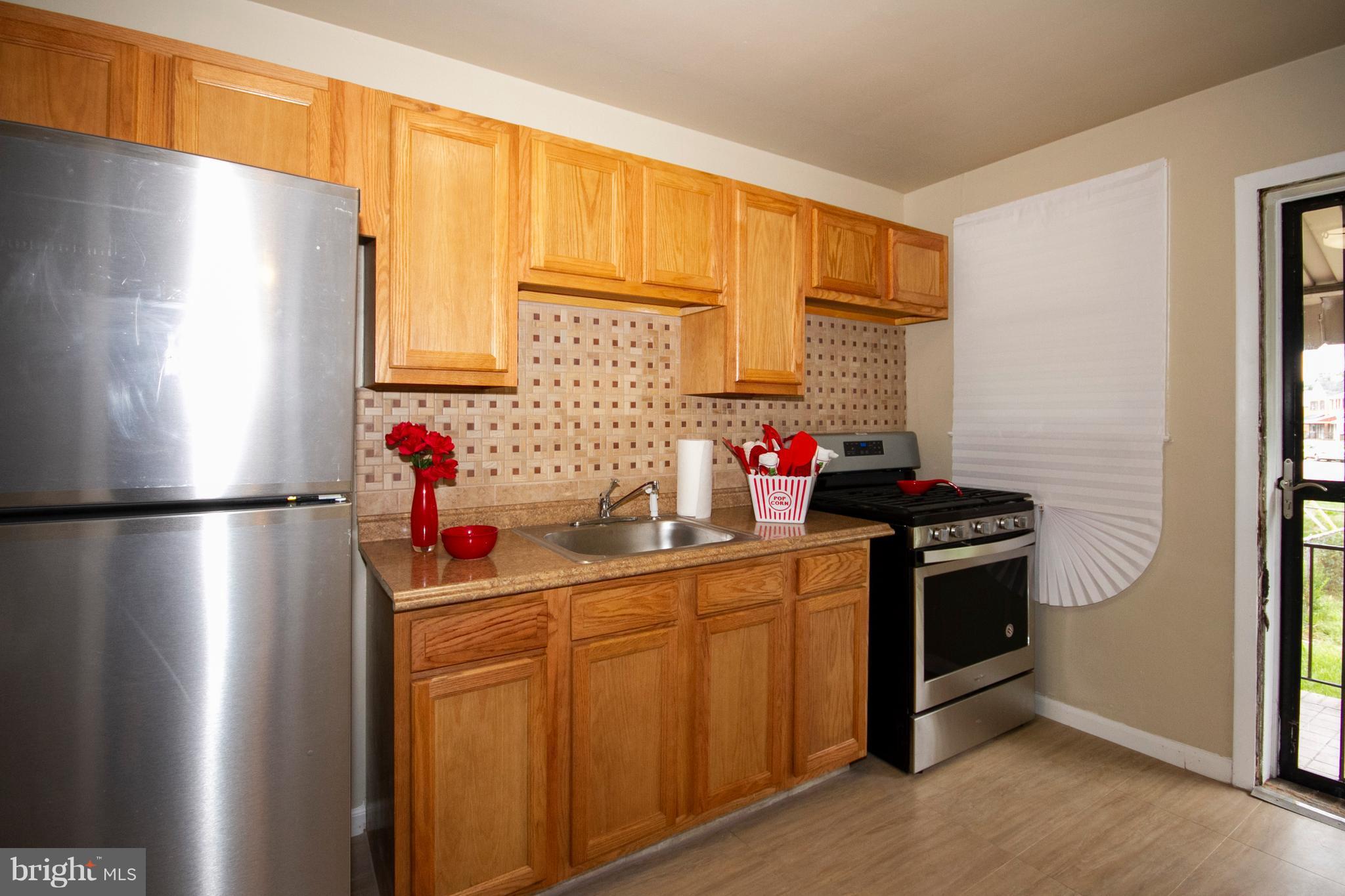 2022 Crestview Road Baltimore, MD 21239 - Photo 6 of 14 a kitchen with stainless steel appliances a refrigerator sink and cabinets