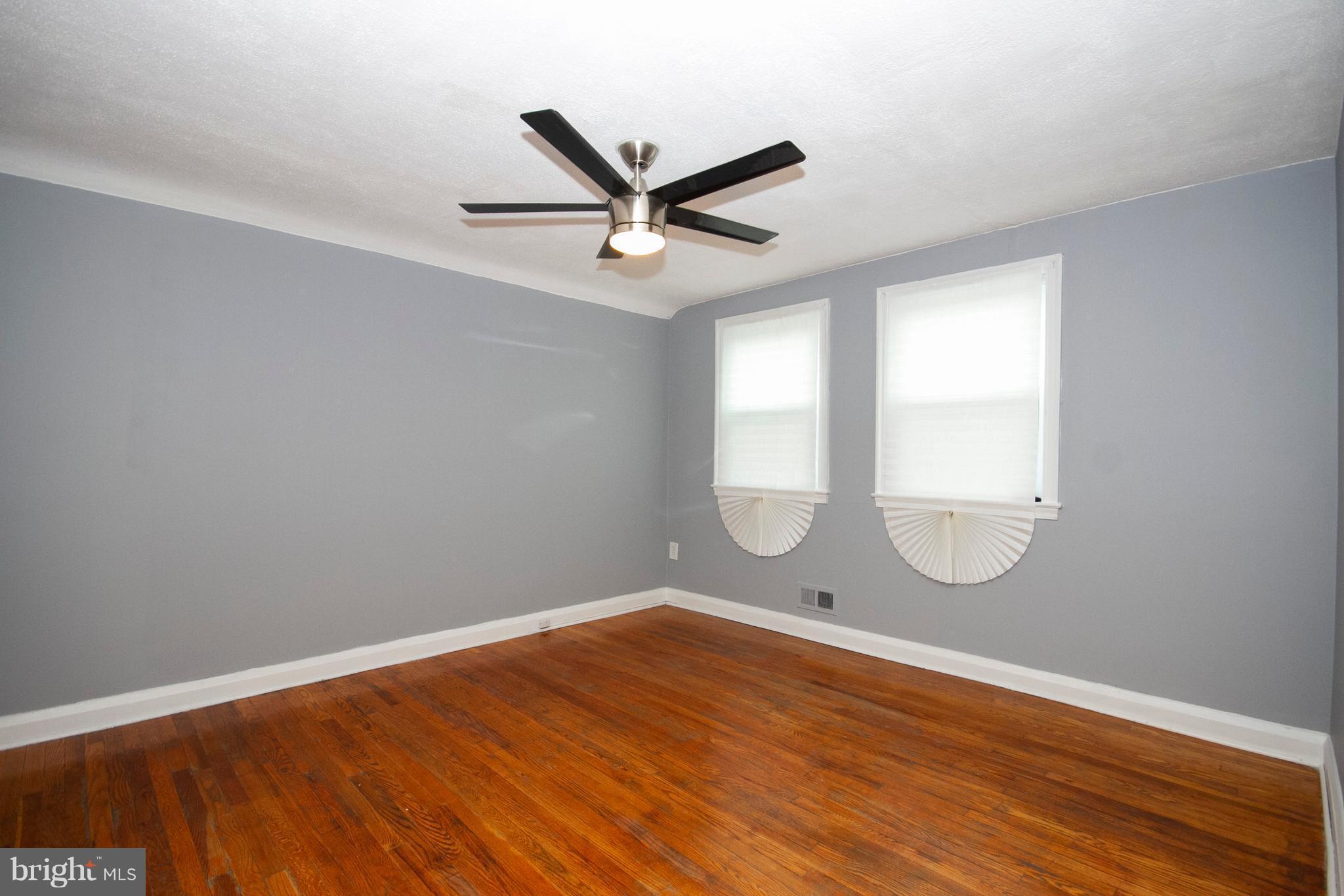 2022 Crestview Road Baltimore, MD 21239 - Photo 10 of 14 an empty room with wooden floor and windows