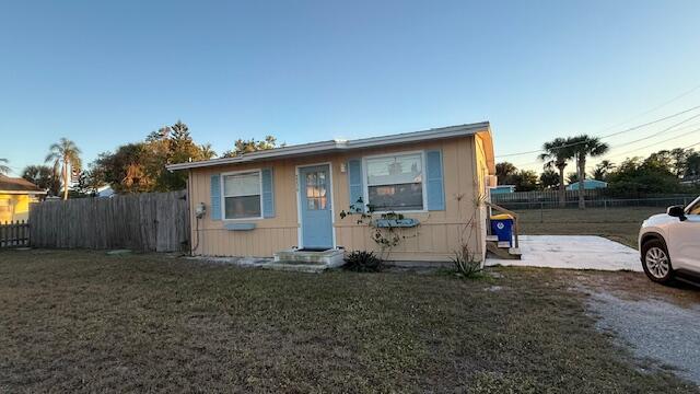 2234 Northeast Pine Ridge Street Jensen Beach, FL 34957 - Photo 1 of 18 a view of a house with a yard