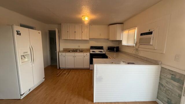 2234 Northeast Pine Ridge Street Jensen Beach, FL 34957 - Photo 11 of 18 a kitchen with a refrigerator a sink and cabinets