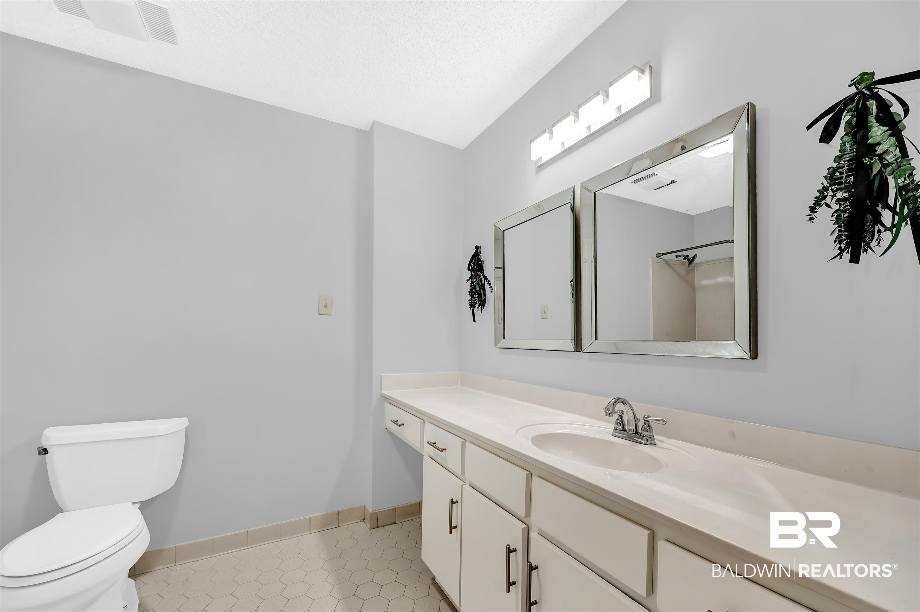 28 Caisson Trace Spanish Fort, AL 36527 - Photo 34 of 51 Bathroom featuring vanity, toilet, visible vents, baseboards, and tile patterned flooring