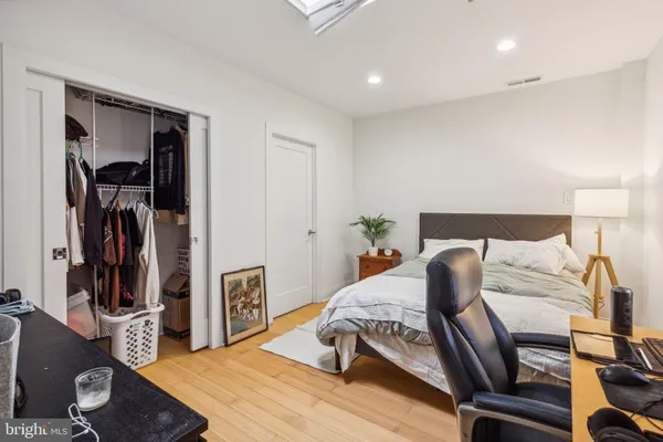 a bedroom with a bed and wooden floor