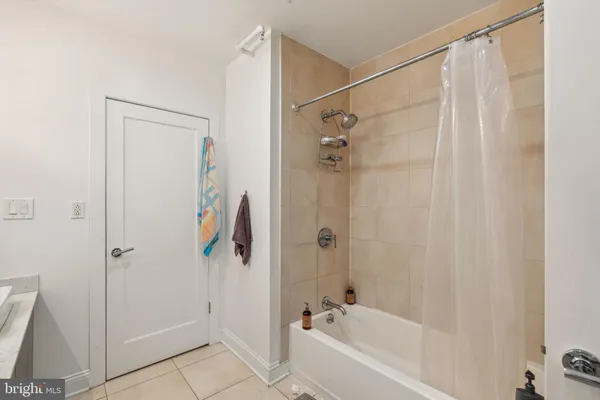 a bathroom with a shower and a bath tub