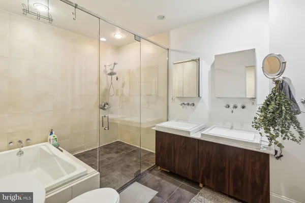 a bathroom with a sink and mirror with toilet