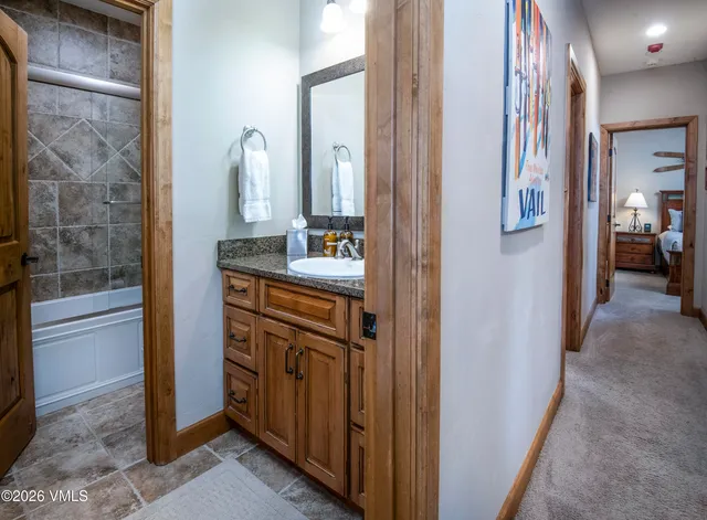 a bathroom with a double vanity sink and a mirror