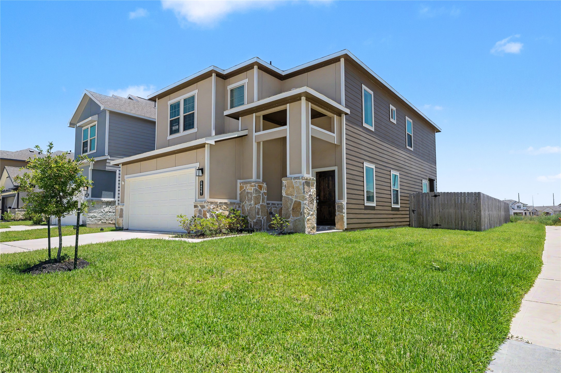 6427 Bolinas Court Rosharon, TX 77583 - Photo 4 of 49 a front view of a house with a yard and garage