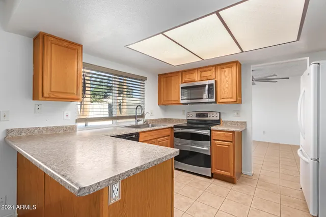 a kitchen with stainless steel appliances granite countertop a sink and a stove