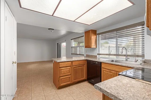 a kitchen with granite countertop cabinets stainless steel appliances and a sink