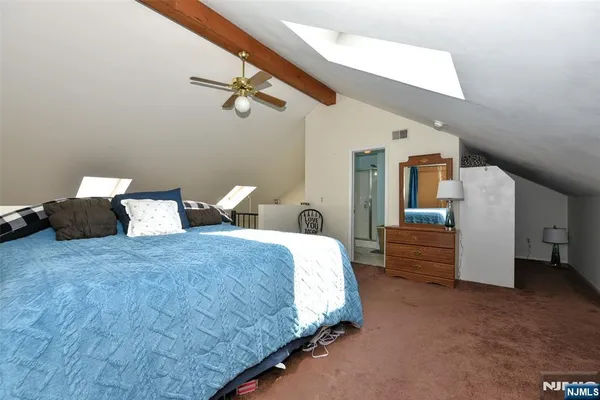 a bed room with a bed and dresser