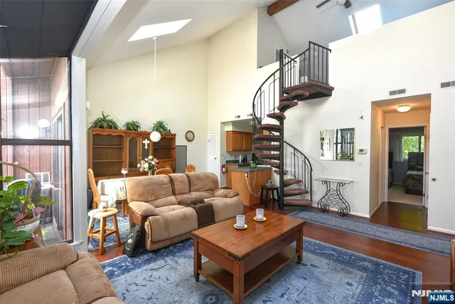 a living room with furniture a rug and a window