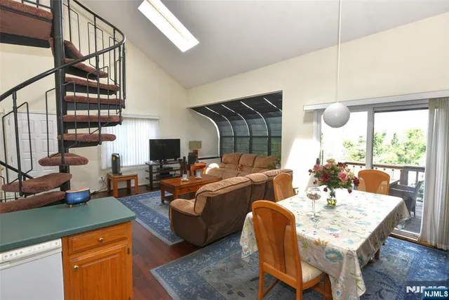 a dining room with furniture and a floor to ceiling window