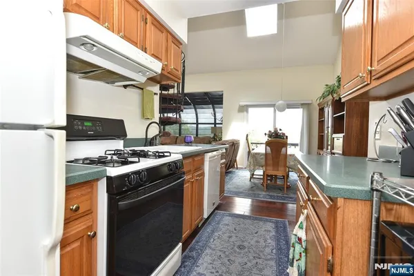 a kitchen with stainless steel appliances granite countertop a stove a sink dishwasher and a refrigerator