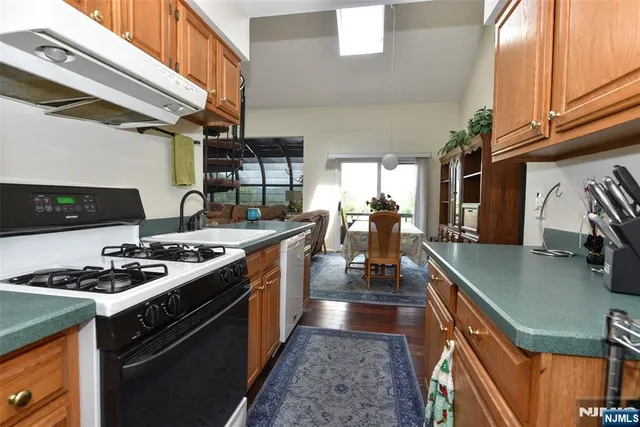 a kitchen with stainless steel appliances granite countertop a stove and a sink