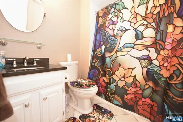 a bathroom with a sink and mirror with toilet