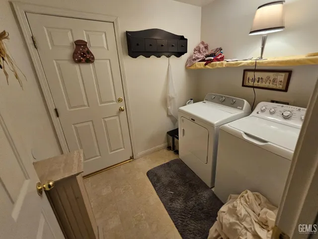 a view of a patio with couches plants and large tree