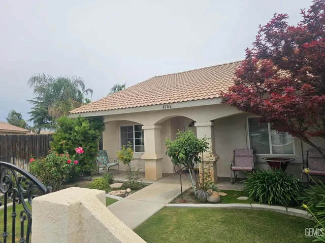 a view of a house with sitting area and garden