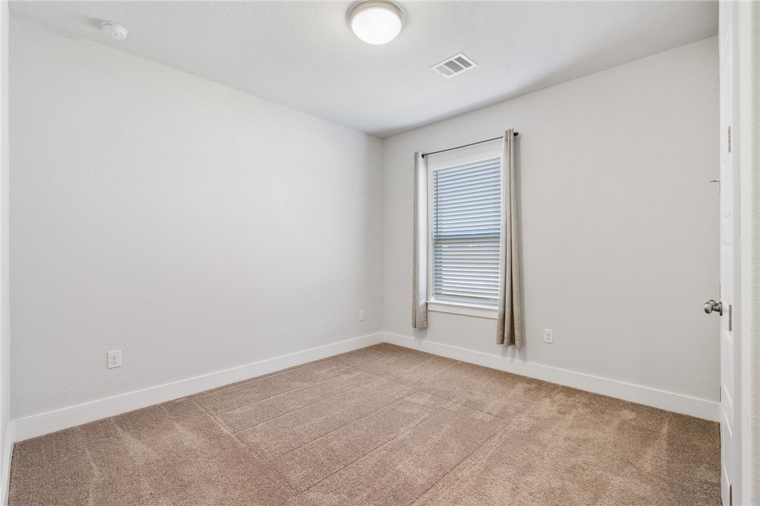 941 Del Raphael Drive Leander, TX 78641 - Photo 18 of 33 The first guest bedroom gets great natural light and sits well away from the primary suite for maximum privacy