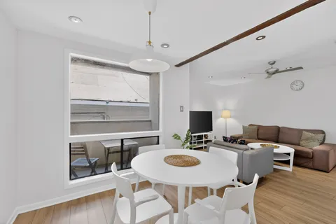 a kitchen with stainless steel appliances kitchen island granite countertop a table and chairs in it