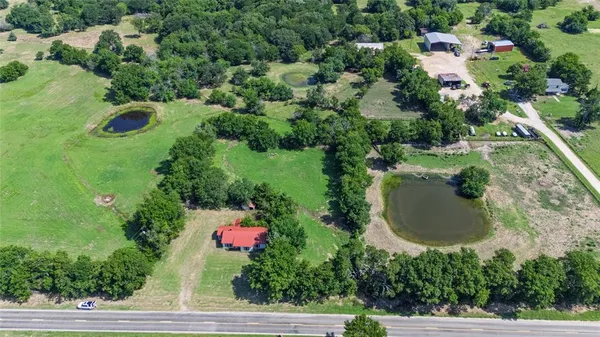 an aerial view of a house with a yard and lake view