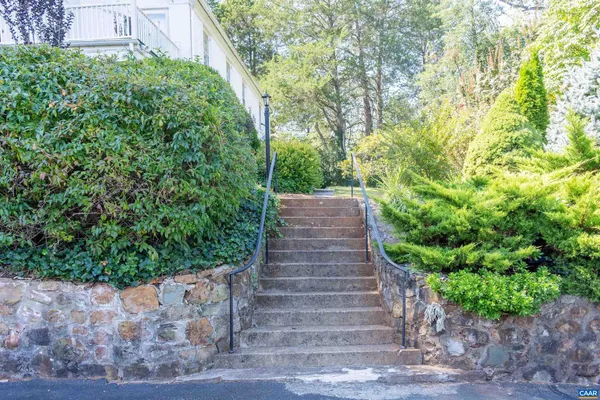 a living room with furniture a rug and a fireplace