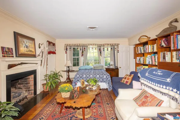 a room with furniture a rug and a window