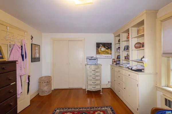 a view of a hallway with closet and wooden floor