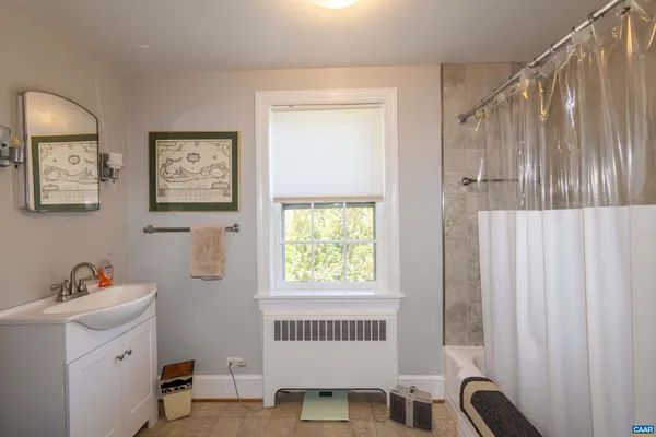 a bathroom with a sink toilet and window