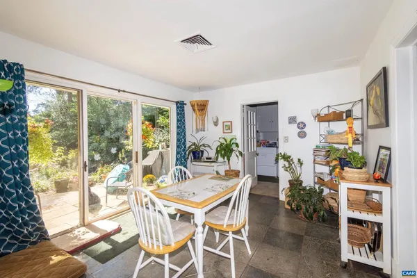 a living room with fireplace furniture and a large window