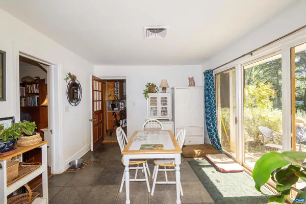 a view of an entryway with wooden floor windows and a chandelier