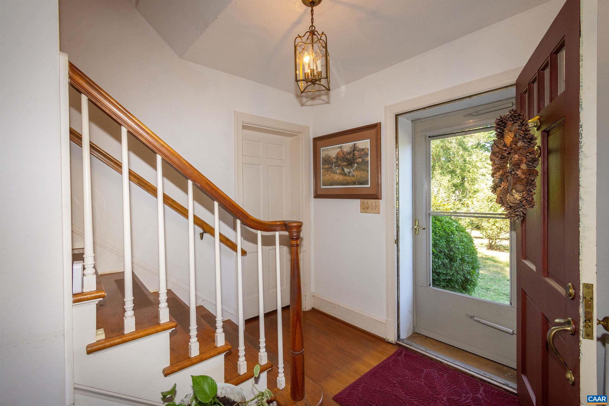 358 Main Street East Orange, VA 22960 - Photo 44 of 56 a view of an entryway with wooden floor windows and a chandelier
