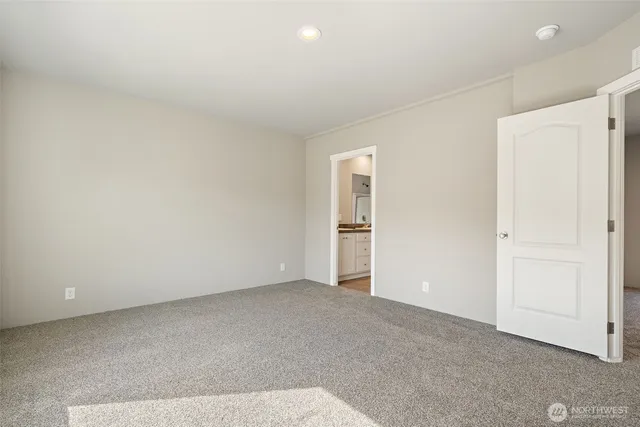an empty room with closet and windows