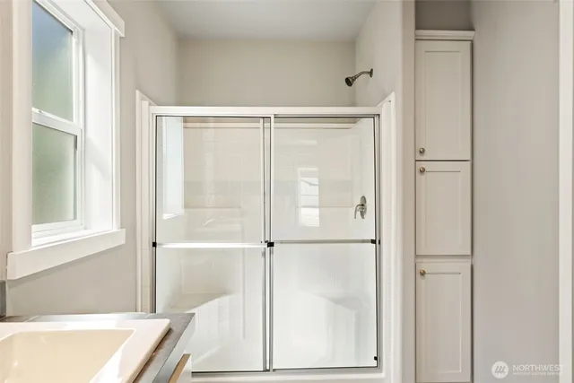 a bathroom with a tub and shower