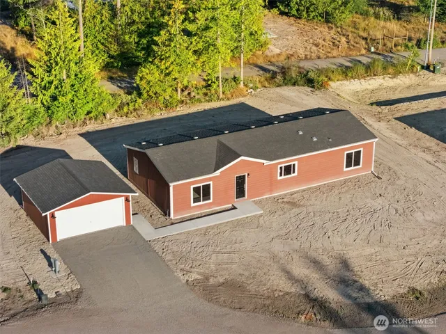 an aerial view of a house with a yard