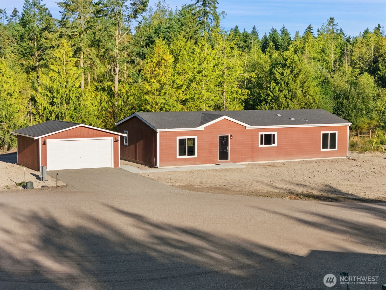 74 Butterfly Lane Sequim, WA 98382 - Photo 34 of 34 a backyard of a house with large trees