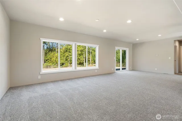 a view of a livingroom with an empty space and a window