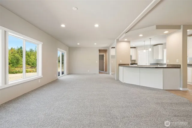 a view of a kitchen with large windows