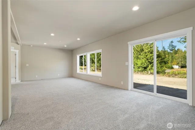 a view of a big room with windows and chandelier